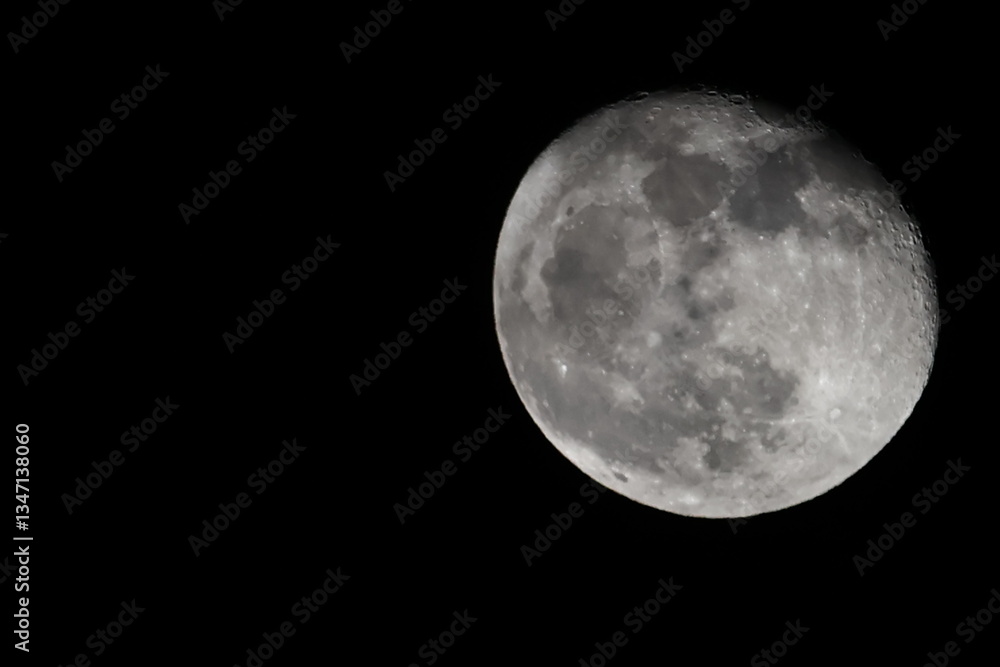 A natural view of the moon partially covered by soft clouds in the night sky. A serene and atmospheric scene capturing the beauty of the celestial landscape A natural view of the moon partially covered by soft clouds in the night sky. A serene and atmospheric scene capturing the beauty of the celestial landscape
