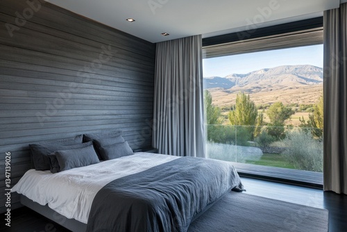 A modern bedroom with a scenic view of the mountain landscape