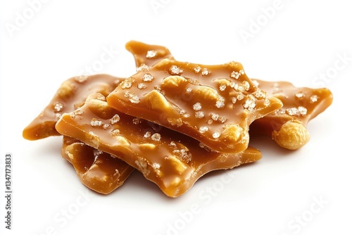 Delicious peanut brittle, golden brown caramel candy with crunchy peanuts and sprinkled sea salt.