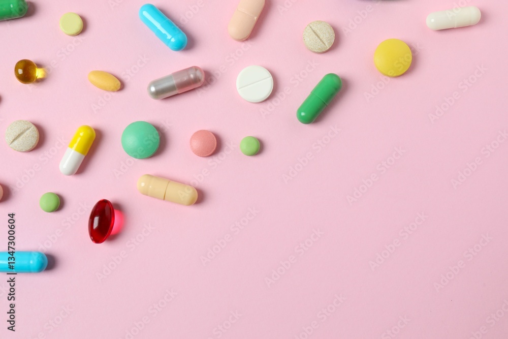 Various pills on color background, top view