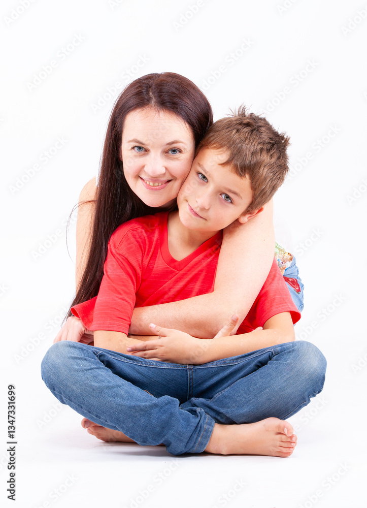 A woman and a boy are sitting on the floor A woman and a boy are sitting on the floor
