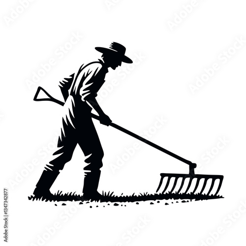Silhouette of a farmer raking soil with a tool in a field
