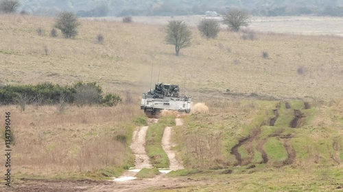 a British army General Dynamics Ajax Ares tank being tested across muddy ground