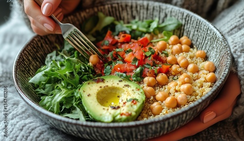 Enjoying a Healthy Vegetarian Meal With Quinoa, Chickpeas, and Fresh Vegetabl...