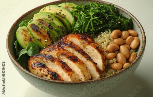 Grilled Chicken Bowl With Quinoa, Avocado Slices, and Sauted Greens on a Whit...