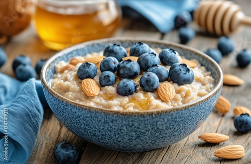 Delicious Bowl of Oatmeal Topped With Blueberries and Almonds Served on Woode...