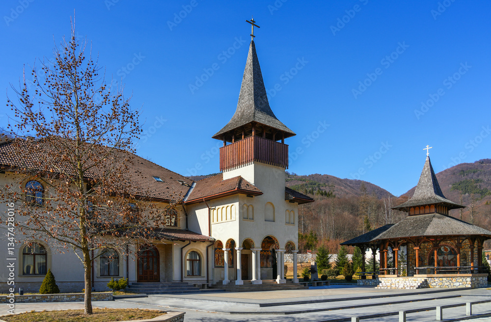 Obraz premium Image of the Lupșa Monastery, Transylvania, Romania, Europe. The monastery was founded in 1429 and is the oldest but also the best preserved wooden church in the Apuseni Mountains.