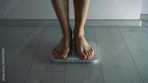 A person is weighed on scales.
Scales for measuring body weight.
A person steps on the scales