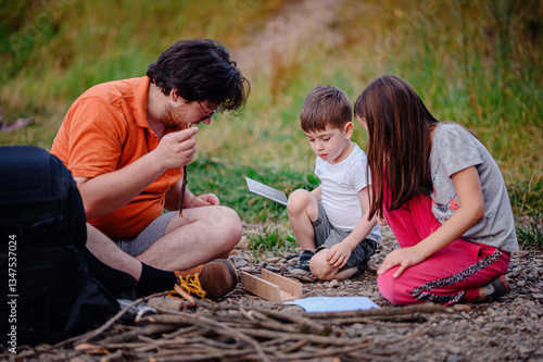 Father Teaching Kids Outdoor Skills in Nature
