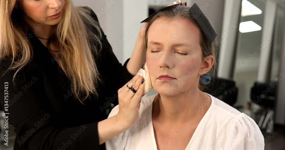 Make up artist doing professional make up of young woman. Make up artist doing professional make up of young woman.
