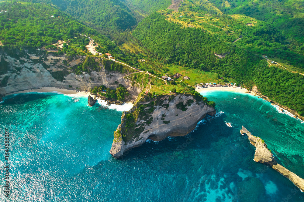 Cinematic aerial landscape shots of the beautiful island Diamond beach of Nusa Penida. Huge cliffs by the shoreline and hidden dream beaches with clear water.
