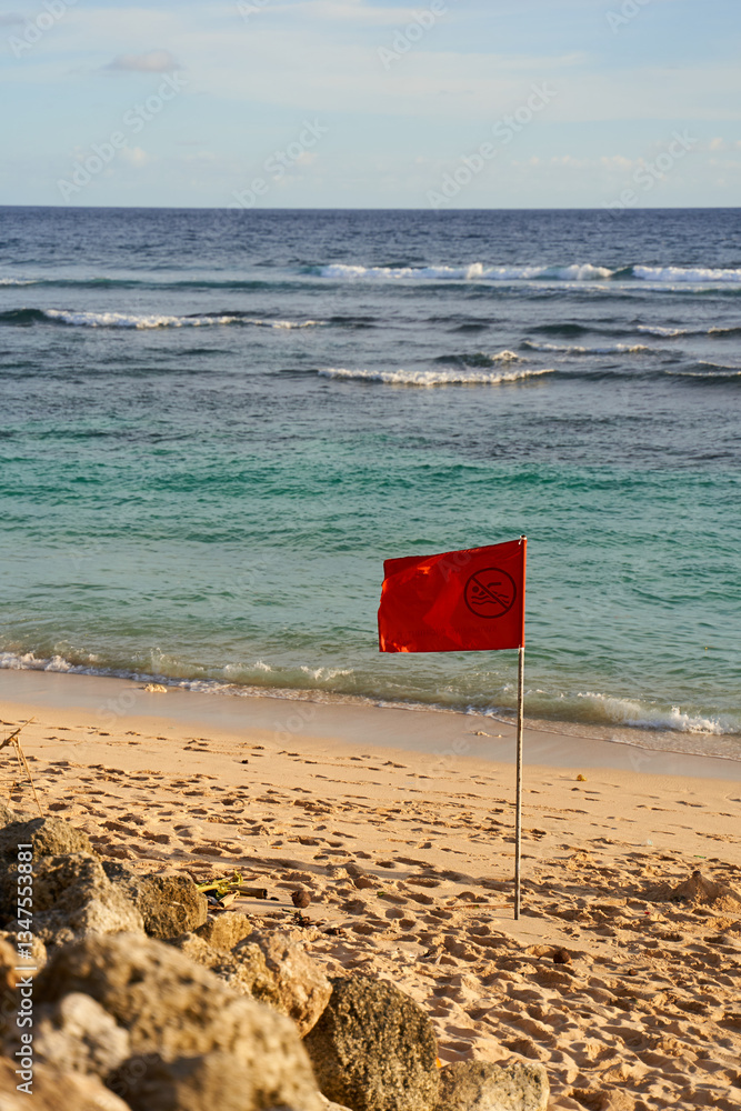 A red flag is posted on the ocean beach due to the risk of a possible storm.