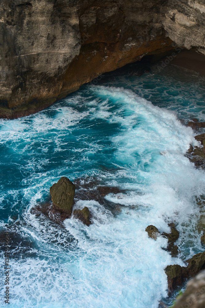 Cinematic aerial landscape shots of the beautiful island of Nusa Penida. Huge cliffs by the shoreline and hidden dream beaches with clear water and foaming wave.