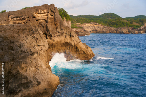 Obraz na płótnie Cinematic aerial landscape shots of the beautiful island of Nusa Penida. Huge cliffs by the shoreline and hidden dream beaches with clear water and foaming wave. w salonie