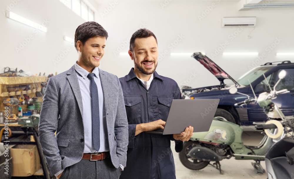 Auto mechanic with a client standing in a car garage Auto mechanic with a client standing in a car garage
