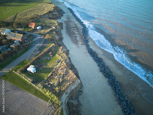 aerial view of Happisburgh, Norfolk, UK, a coastline threatened by rising sea level and coastal erosion