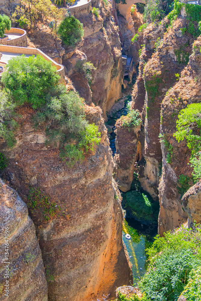 The rocky, sheer-sided limestone cliffs of Ronda Gorge (El Tajo de Ronda) plummet 390 feet (120 meters) to Guadalevin River. Ronda, Province of Malaga, Spain.