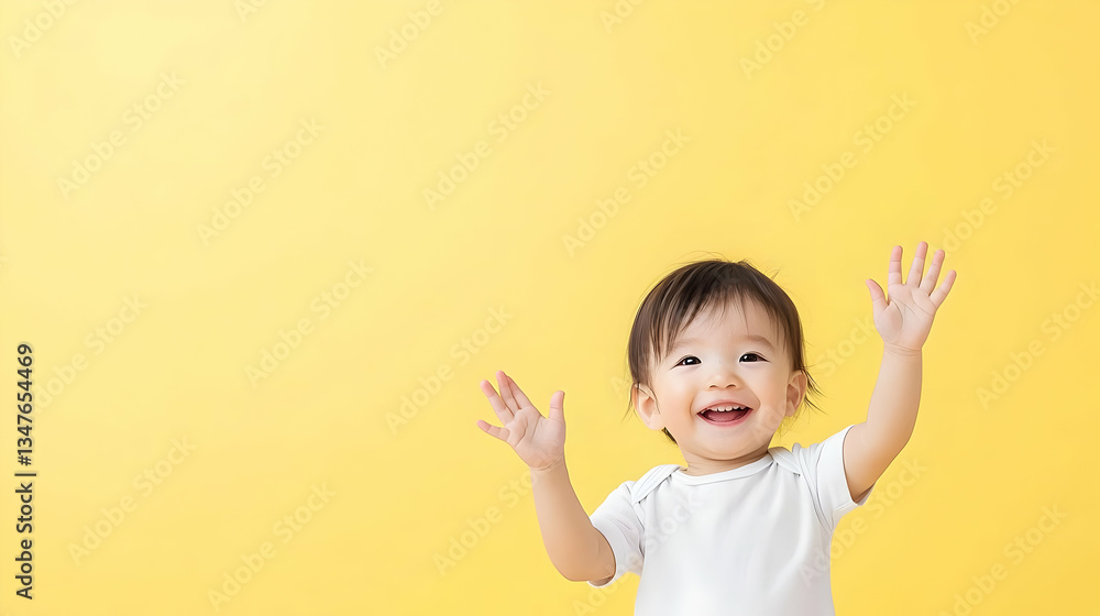 Happy Baby With Hands Up Against Yellow Background Happy Baby With Hands Up Against Yellow Background