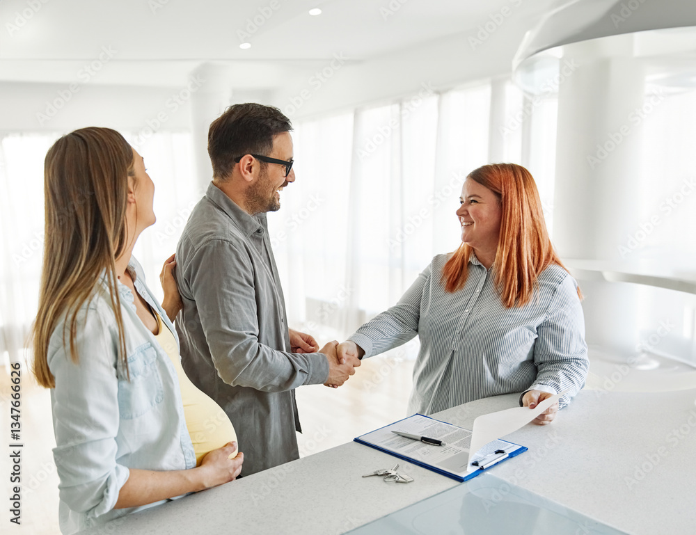 Fototapeta premium couple house property agent home real estate business buying agreement deal client buyer new loan pregnant pregnancy mother meeting agreement contract maternity belly shaking hands handshake
