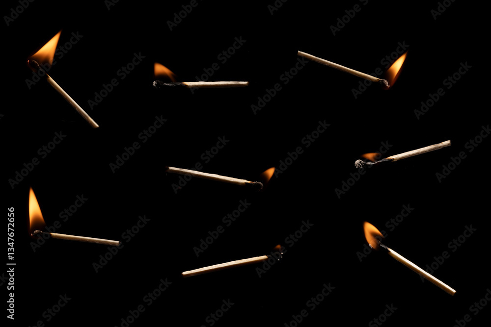 Lit falling match on a black background. Lit falling match on a black background.