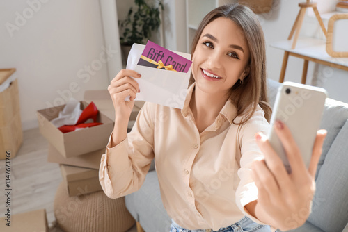 Young woman with gift card ...