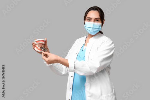 Young female dentist in mas...