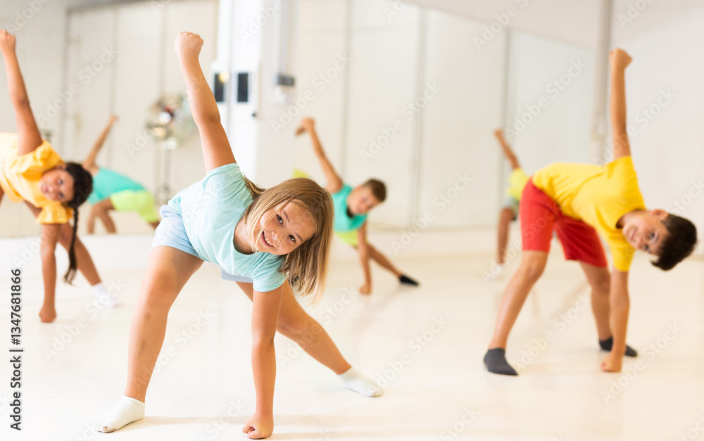 Obraz premium Happy kids having fun in a choreography studio during dance lesson