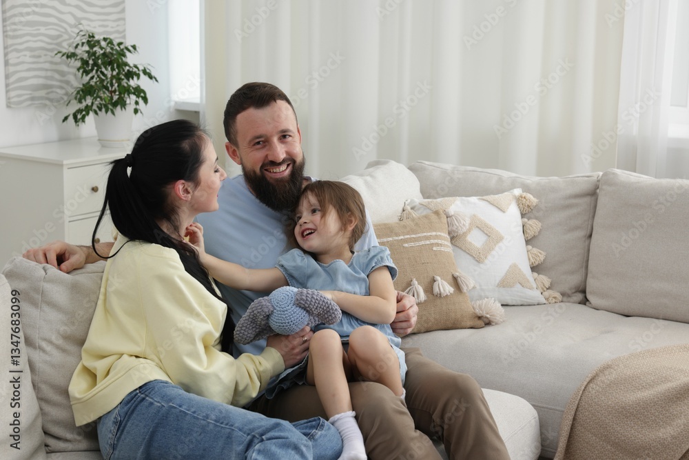 Cute little girl and her parents spending time together at home Cute little girl and her parents spending time together at home