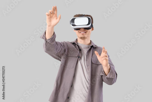 Young man using VR glasses ...