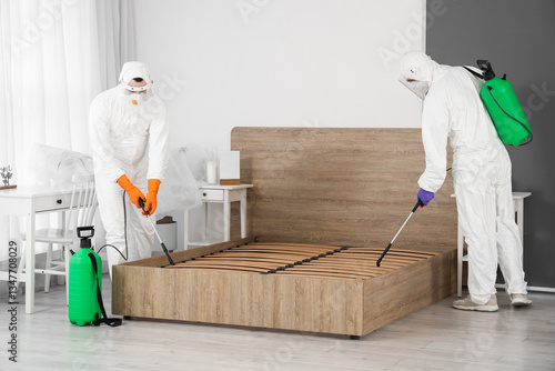 Male workers disinfecting b...