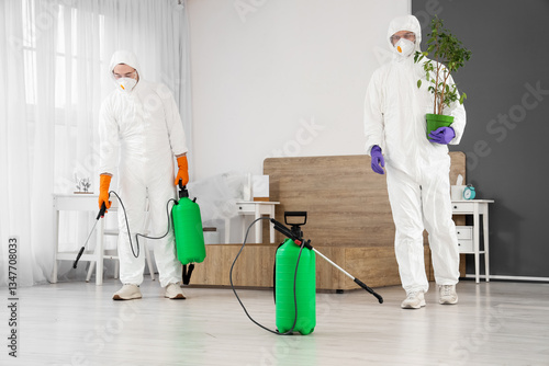 Male workers in hazmat suit...