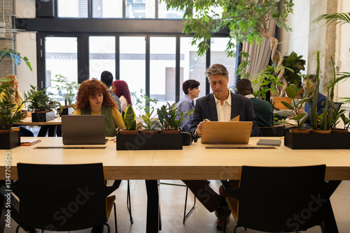 Business people working in modern green coworking space