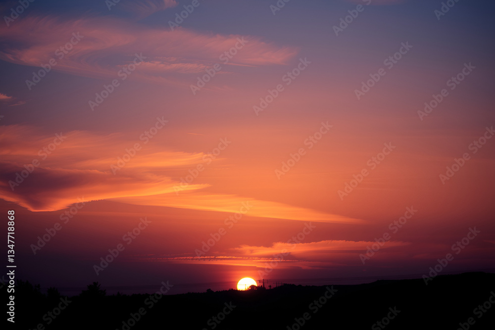 Fototapeta premium Beautiful sunset over the mountains with colorful sky and clouds