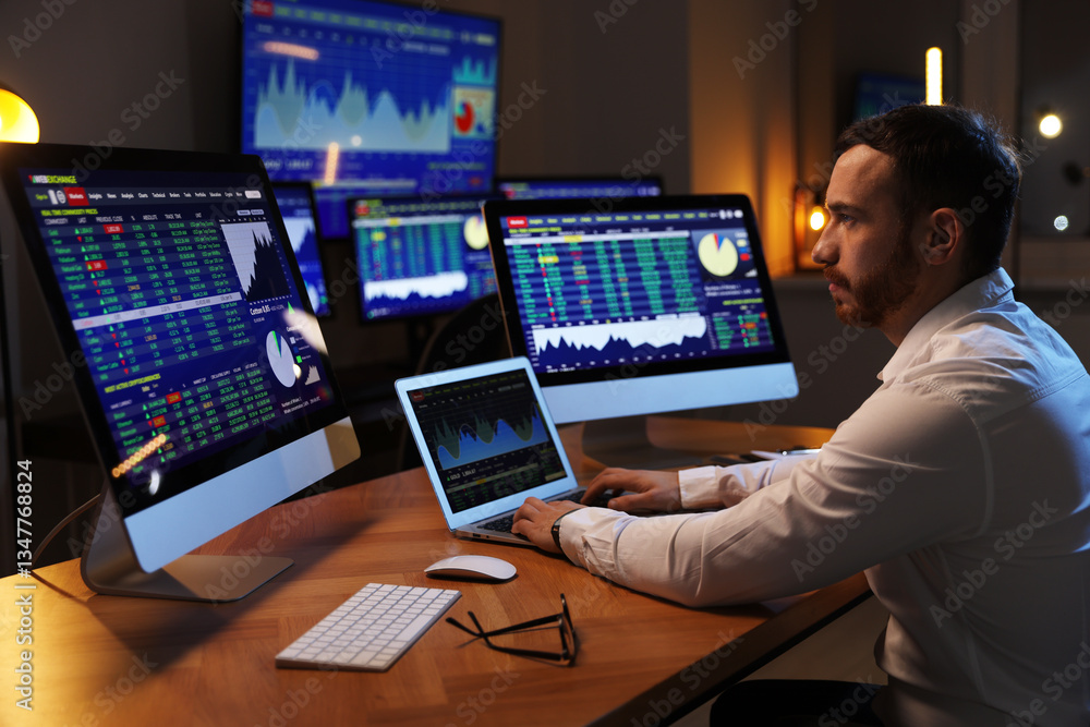 Financial trading specialist working in office at night Financial trading specialist working in office at night