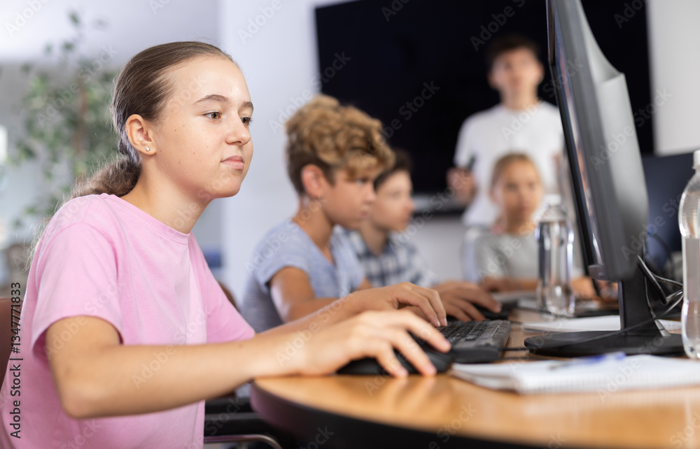 Portrait of female schoolgirl at computers in shool computer class Portrait of female schoolgirl at computers in shool computer class