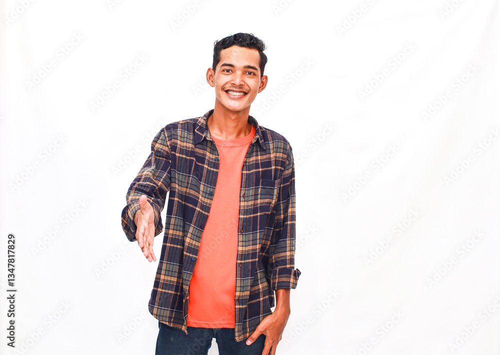 Friendly young man offering handshake against a plain white studio backdrop Friendly young man offering handshake against a plain white studio backdrop