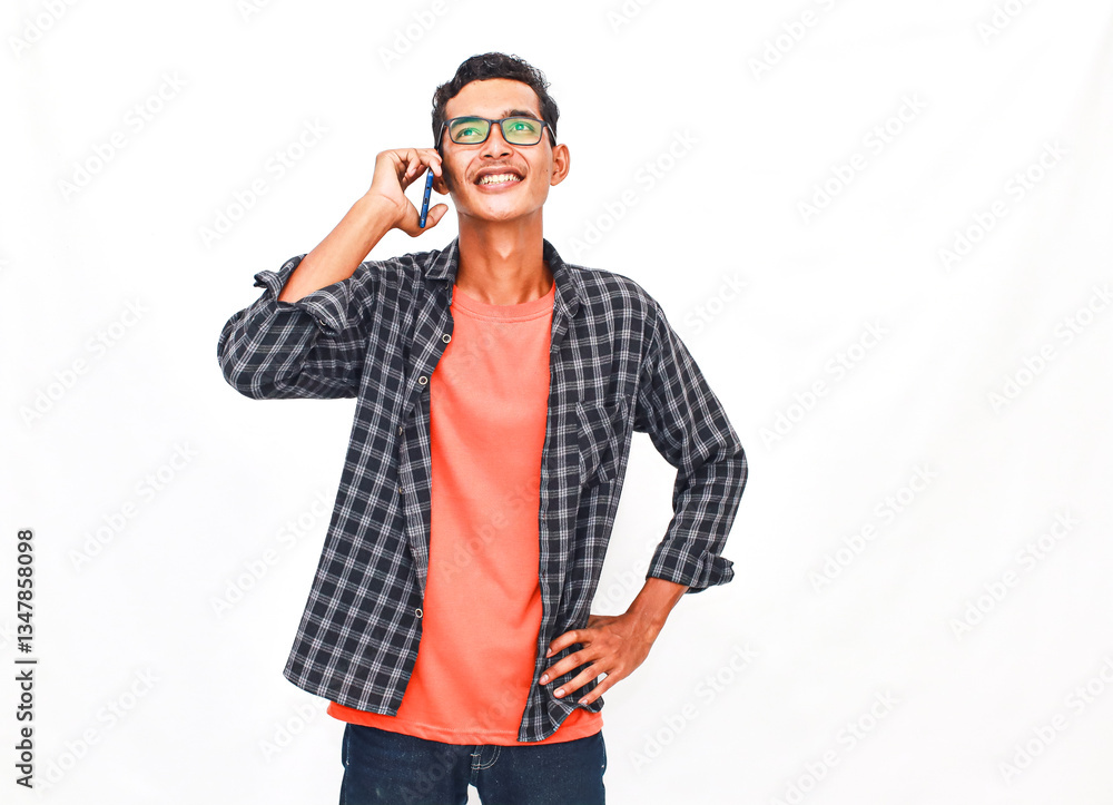 Young Man On Phone Call Against Plain Background Young Man On Phone Call Against Plain Background