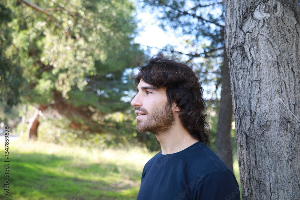Young Long Hair Man Marveled In Nature Near A Tree Young Long Hair Man Marveled In Nature Near A Tree