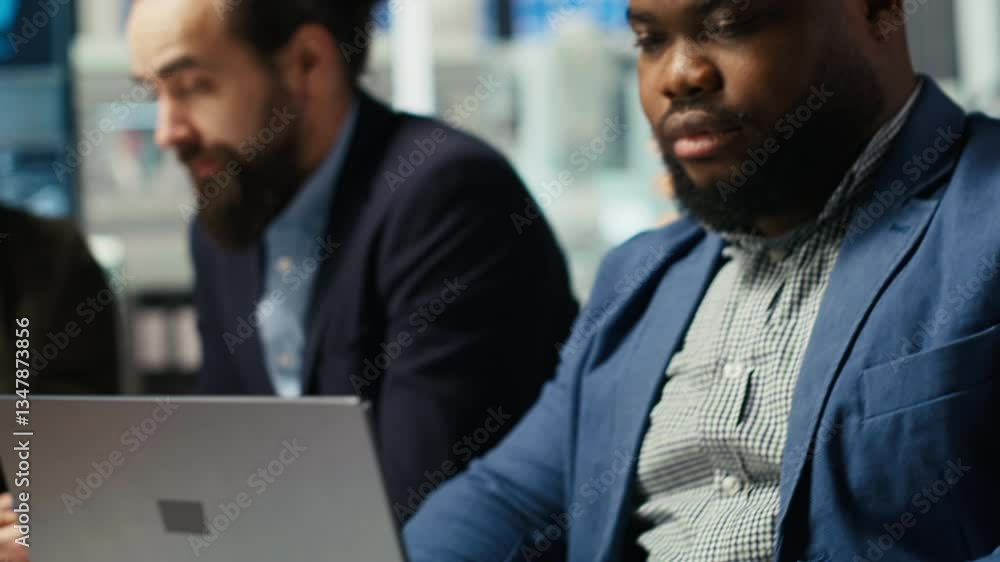 Engineers in factory office using laptop to collect performance data to refine designs for increased energy output. Photovoltaics plant experts design innovative solar cell prototypes, camera B