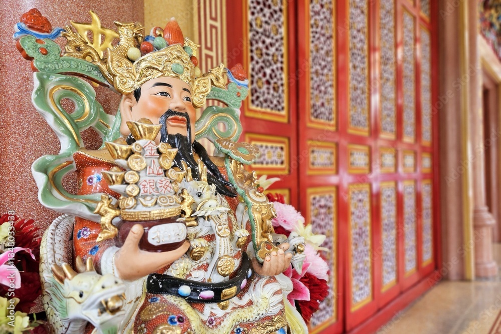 Fototapeta premium Close up Cai Shen, God Of Wealth Statue in front of Chinese Shrine.
