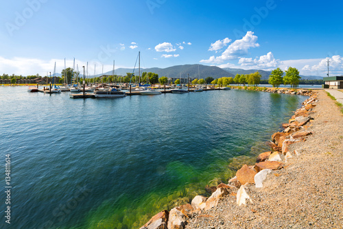 The marina in the downtown lakefront district of Sandpoint, Idaho, with boats filling the docks on Lake Pend Oreille on a summer day in the North Idaho panhandle.	