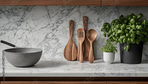 Stylish kitchen setting featuring wooden cooking utensils, herbs in pots, and a grey speckled pan on a marble countertop.  Perfect for cooking, food blogs, or home decor.