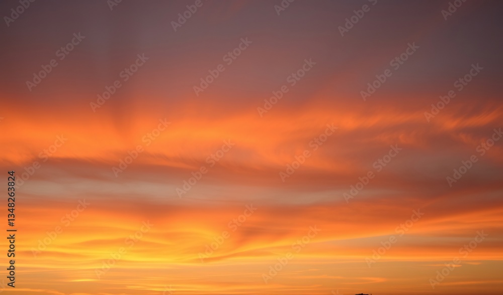 Obraz premium Fiery sunset clouds glow warmly across the canvas a breathtaking fiery spectacle. AI Generated