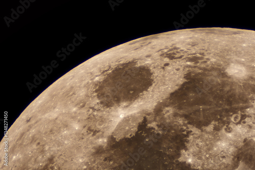 Telescopic view of the moon revealing craters and lunar seas