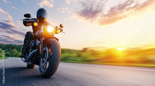 A motorcyclist rides a powerful cruiser motorcycle at sunset on a scenic country road enjoying the thrill of an open road adventure.