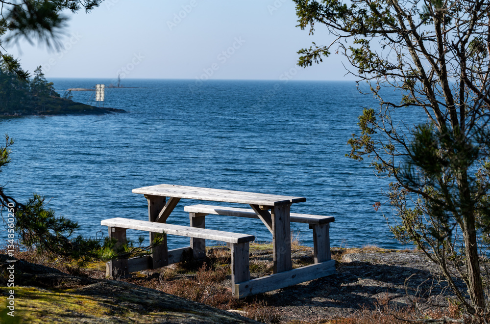 Wooden benches and table overlooking lake Vattern Sweden Wooden benches and table overlooking lake Vattern Sweden