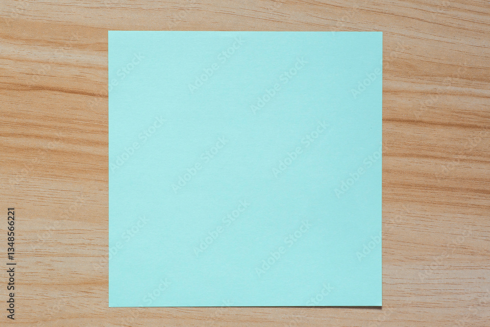 light green blank piece of paper laying on wooden table light green blank piece of paper laying on wooden table
