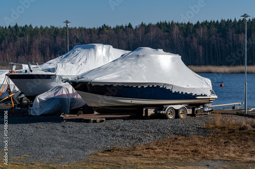 Two motor boats with plastic cover for winter storage
