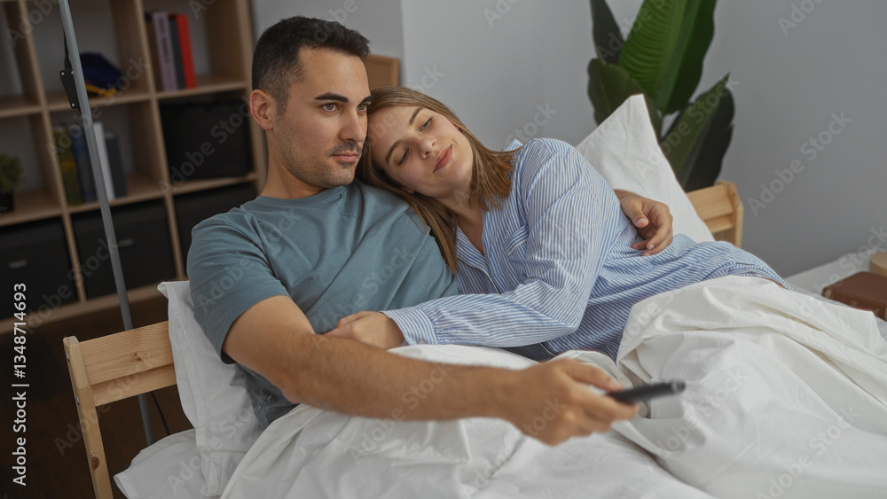 Fototapeta premium Couple relaxing in a cozy bedroom watching tv as the woman rests her head on the man's shoulder enjoying a peaceful moment together indoors.