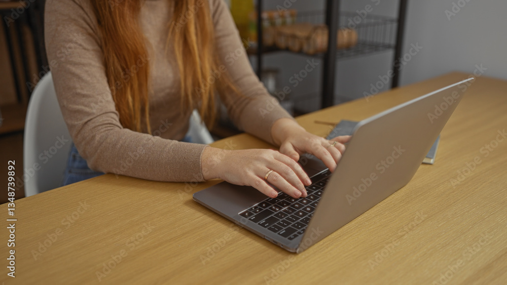 Fototapeta premium Woman using laptop in a modern office setting, focusing on work with hands typing on keyboard at desk, capturing an atmosphere of professional productivity indoors.